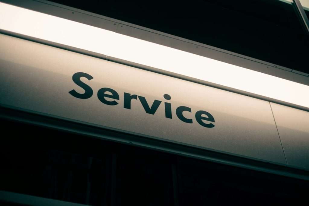 white and black sign that reads services